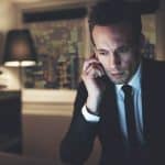 Picture of financial advisor on phone in hotel room