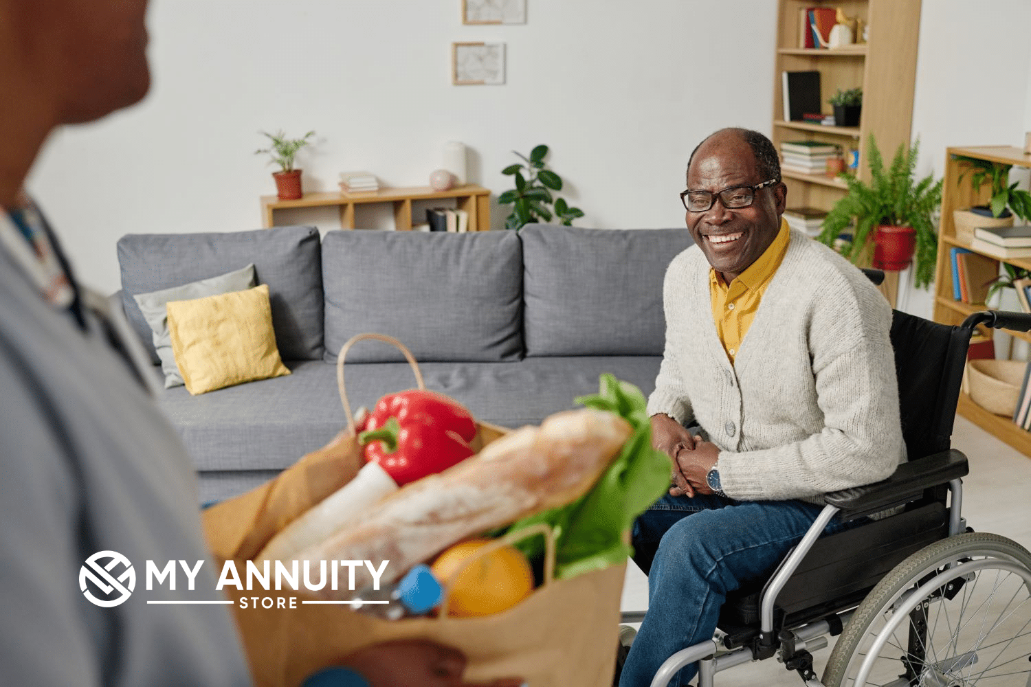 Disabled African American Man in a wheel-chair lookin at wife who is holding a bag of groceries.