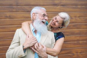 happy retired couple hugging