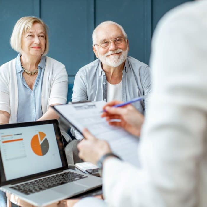 Retired couple sitting accross from their financial advisor.