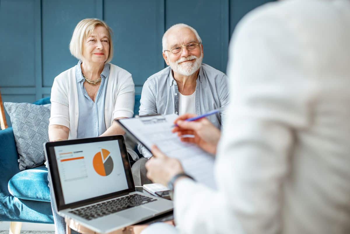 Retired couple sitting accross from their financial advisor.
