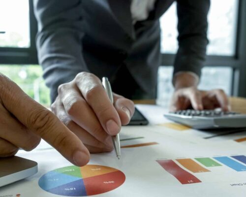 Business team analyzing graphs of asset based long term care options