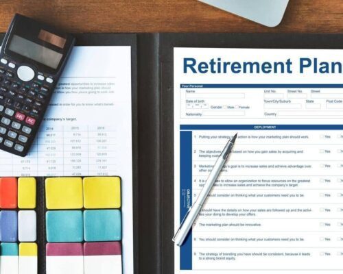 My Annuity Store Hero Image Retirement Planner spread open on wooden desk with colorful charts and calculator